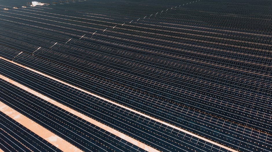 A vast array of solar panels in a solar farm, illustrating renewable energy and sustainability.