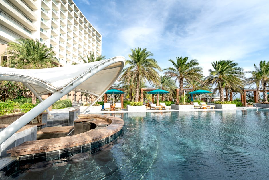 Explore this serene resort poolside, surrounded by lush palm trees and luxury amenities.